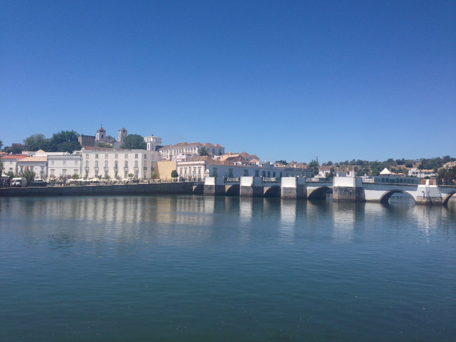 The historic bridge and riverside buildings beside the Gilão River in Tavira, Portugal