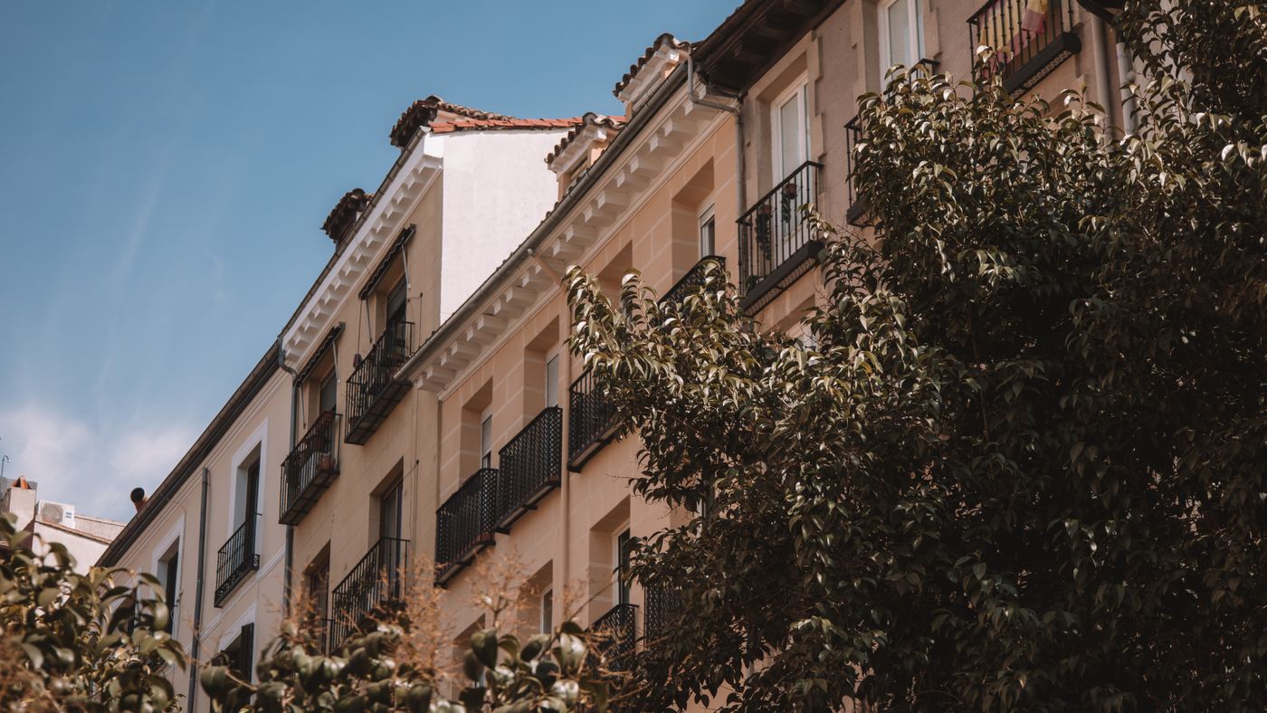 Residential buildings with balconies and leafy trees in Madrid, Spain
